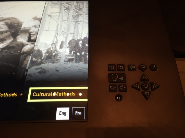 A digital interactive featuring a rubberized keypad with buttons for speak, zoom, back, home, help, and navigation.