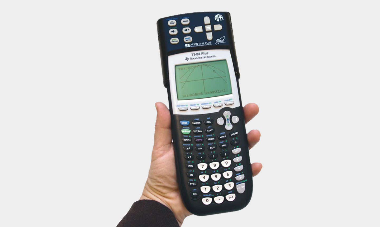 A hand holds up a graphing calculator displaying the front side with a small single-color screen and an extensive array of calculating buttons.